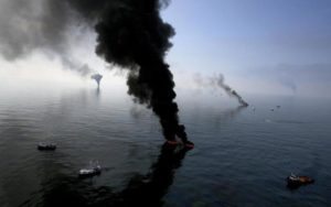 Smoke billows from a controlled burn of spilled oil off the Louisiana coast in the Gulf of Mexico coast line