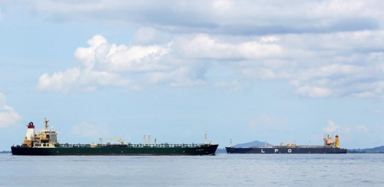 Oil tanker "AS Oceania" sails past a LPG tanker near the Raffles Lighthouse in southern Singapore