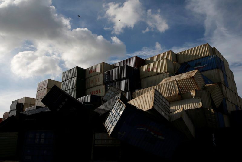 Birds fly over the toppled shipping containers after Typhoon Meranti made landfall, in Kaohsiung, Taiwan September 15, 2016. REUTERS/Tyrone Siu