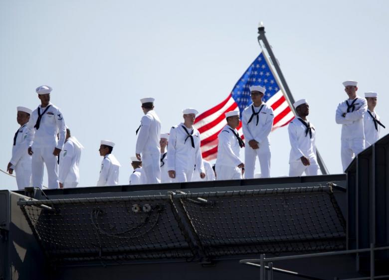 Sailors man rails as USS Ronald Reagan departs for Yokosuka, Japan from Naval Station North Island in San Diego