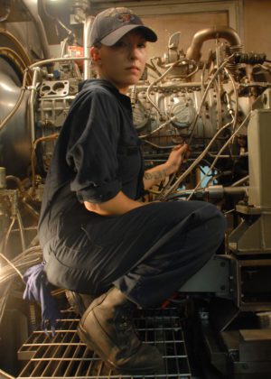 Female Marine Engineer working in Engine Room aboard ship