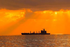 Military Sealift Ship Against Orange Sunset