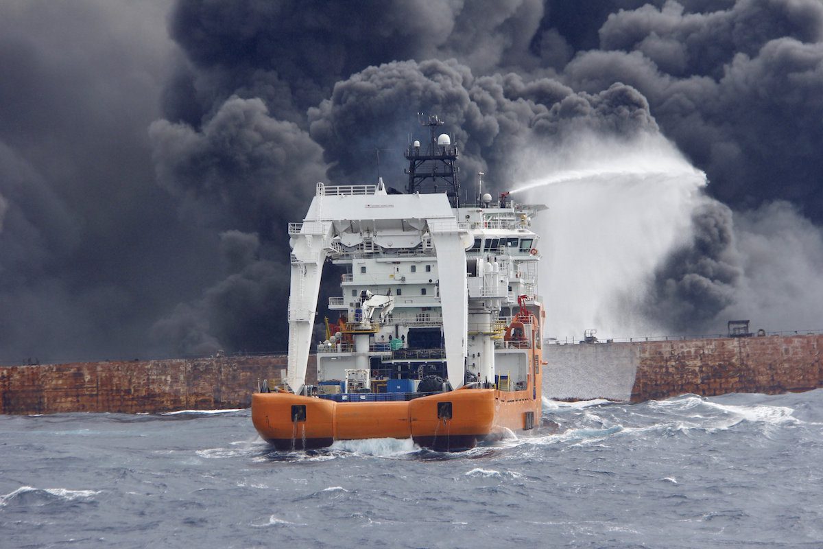 A rescue ship works to extinguish the fire on the burning Iranian oil tanker Sanchi in the East China Sea
