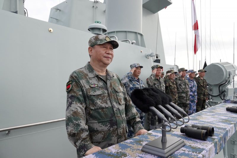 Chinese President Xi Jinping delivers a speech as he reviews a military display of Chinese People's Liberation Army (PLA) Navy in the South China Sea