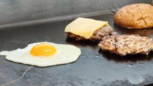 Cooking eggs and burgers
