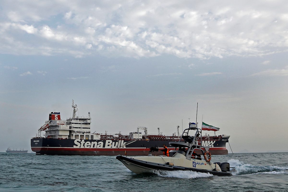A boat of Iranian Revolutionary Guard sails next to Stena Impero, a British-flagged vessel owned by Stena Bulk, at Bandar Abbas port