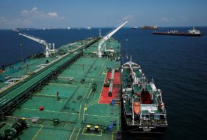 A bunker vessel prepares to supply fuel to Hin Leong's Pu Tuo Shan VLCC supertanker in the waters off Jurong Island in Singapore