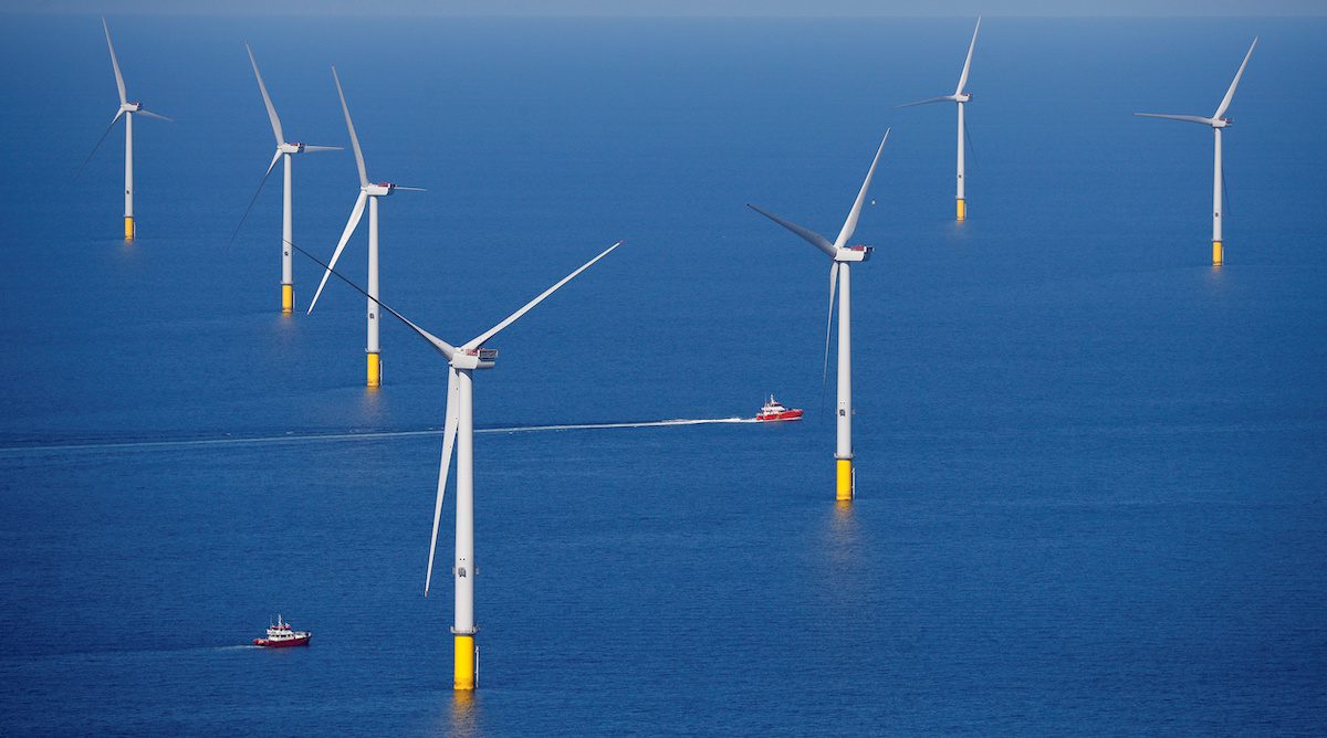 A support vessel is seen next to a wind turbine at the Walney Extension offshore wind farm operated by Orsted off the coast of Blackpool, Britain