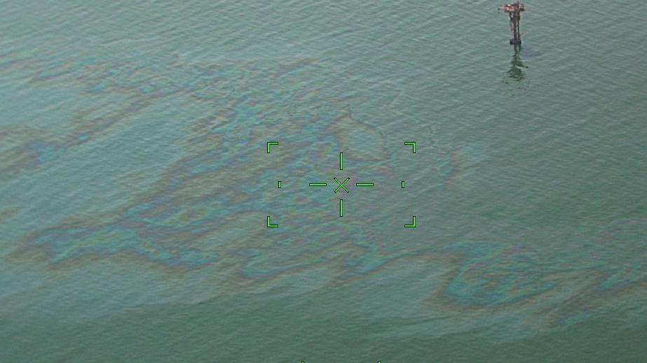 A Coast Guard Aviation Training Center Mobile HC-144 Ocean Sentry airplane crew conducts an overflight assessment Sept. 5, 2021 of the Bay Marchand approximately 2 miles south of Port Fourchon, Louisiana. The crew witnessed an 11-mile rainbow sheen that the Coast Guard is actively monitoring.