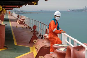 seafarer on deck with a mask