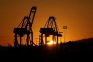 FILE PHOTO: The sun sets behind container cranes at the Port of Los Angeles in Los Angeles, California, U.S. October 14, 2021. REUTERS/David Swanson/File Photo