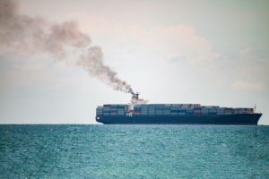 smoke pollution coming from a container ship