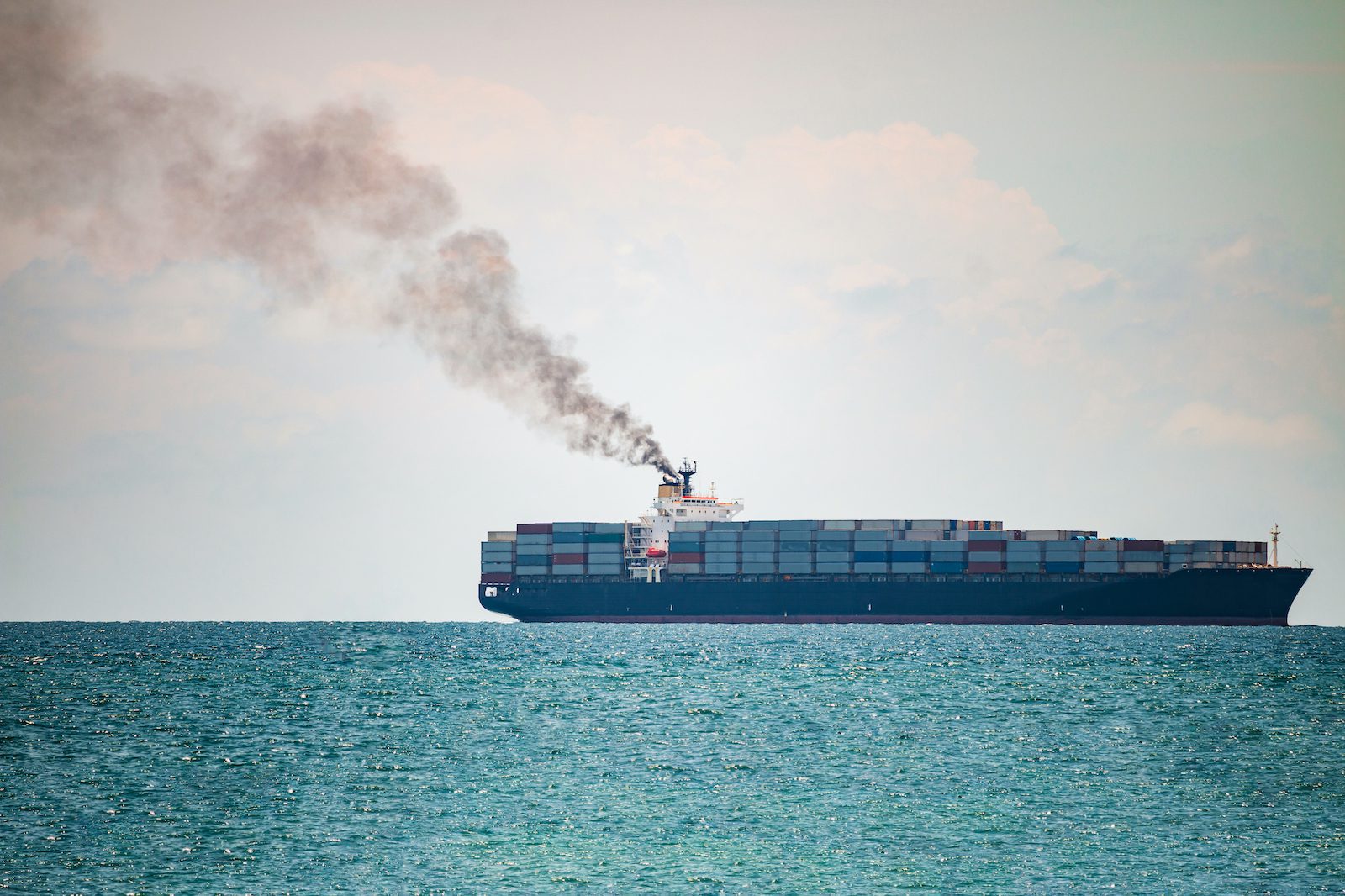 smoke pollution coming from a container ship