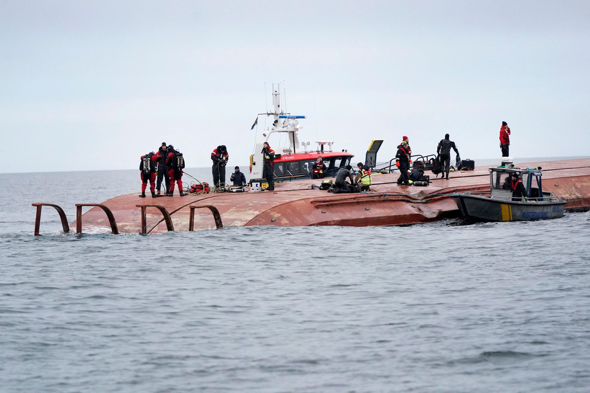 Divers work aboard the Danish cargo ship Karin Hoej which collided with the British cargo ship Scot Carrier between Ystad and Bornholm, on the Baltic Sea December 13, 2021. Johan Nilsson/TT News Agency/via REUTERS