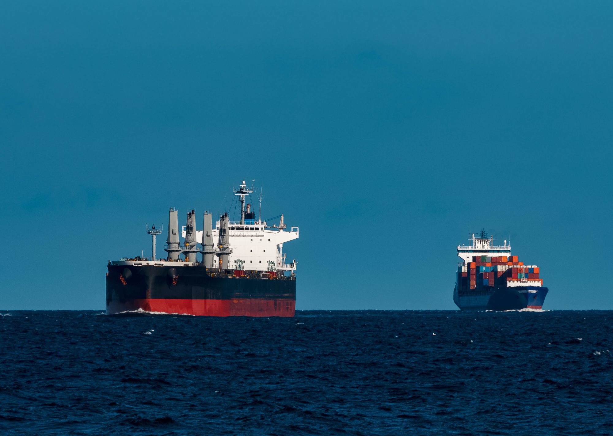 File Photo shows a bulk ship with containership in background