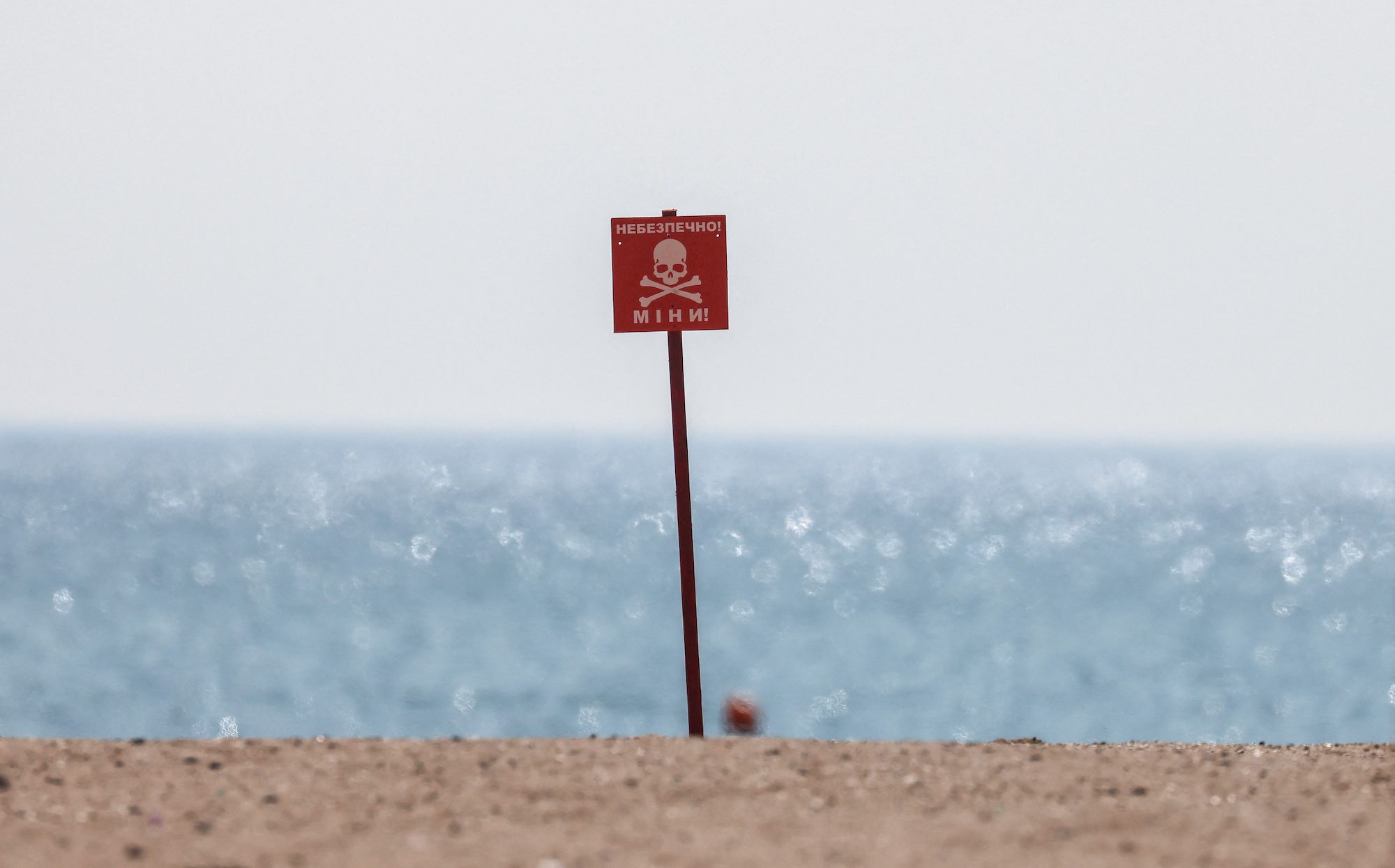 Danger mines sign is pictured at an empty beach, as Russia's invasion of Ukraine continues, in Odesa, Ukraine, March 26, 2022. REUTERS/Nacho Doce
