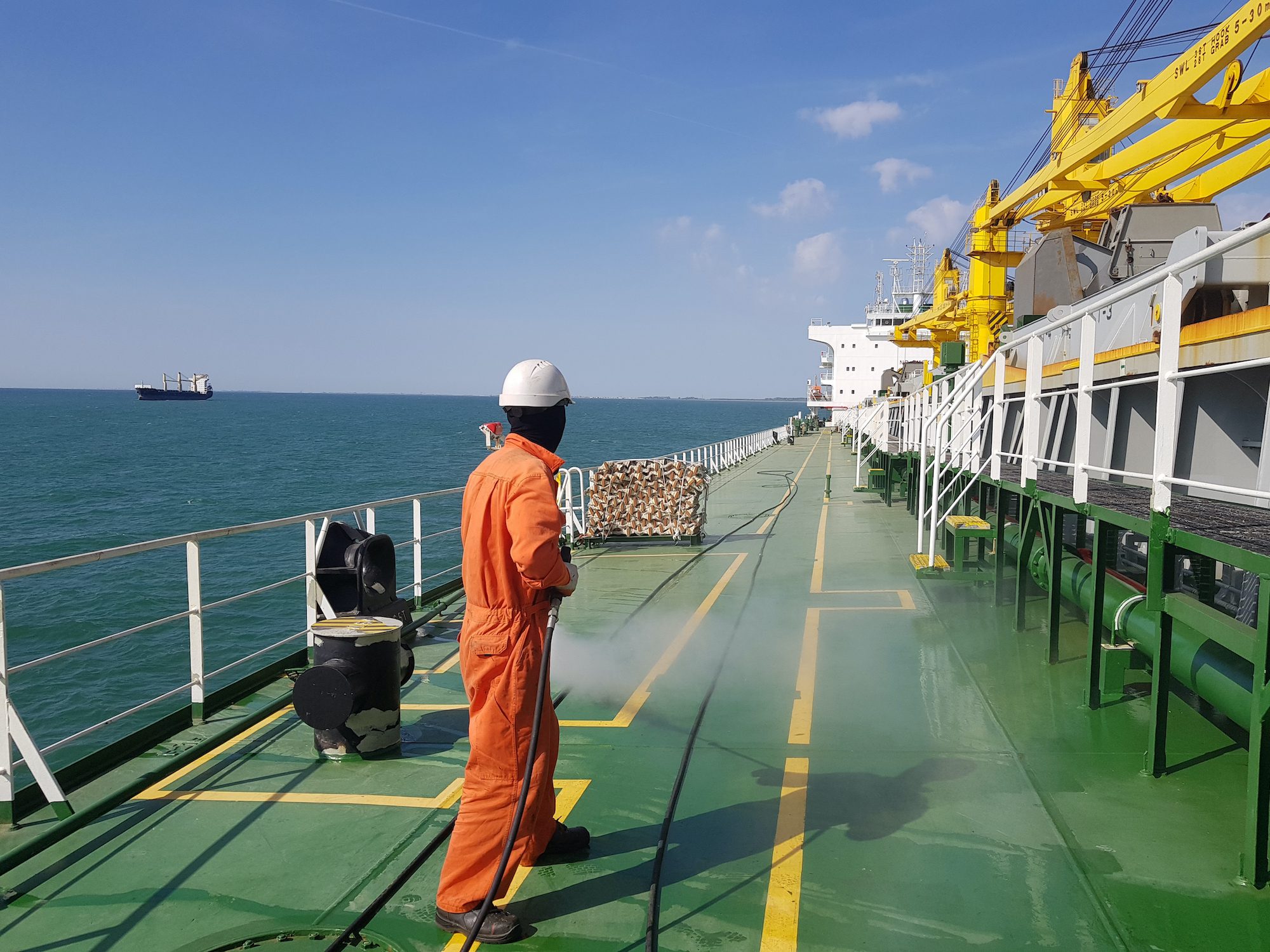 A seafarer working on the deck of a ship