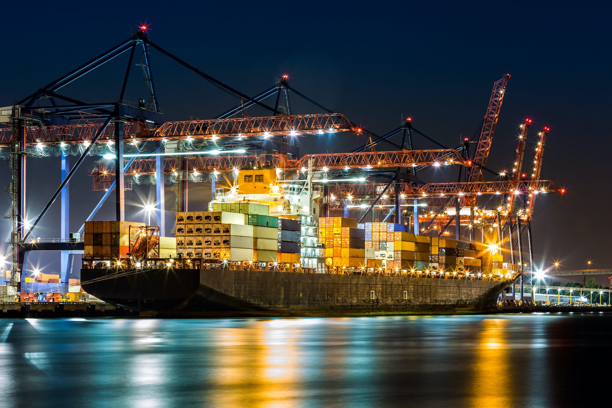 A containership being loaded at the Port of New York and New Jersey at night.