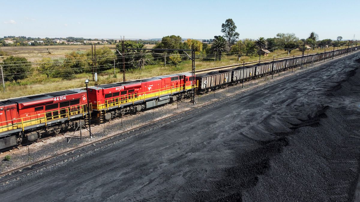 A Transnet Freight Rail train is seen next to tons of coal mined from the nearby Khanye Colliery mine, at the Bronkhorstspruit station, in Bronkhorstspruit, around 90 kilometres north-east of Johannesburg, South Africa, April 26, 2022. REUTERS/Siphiwe Sibeko