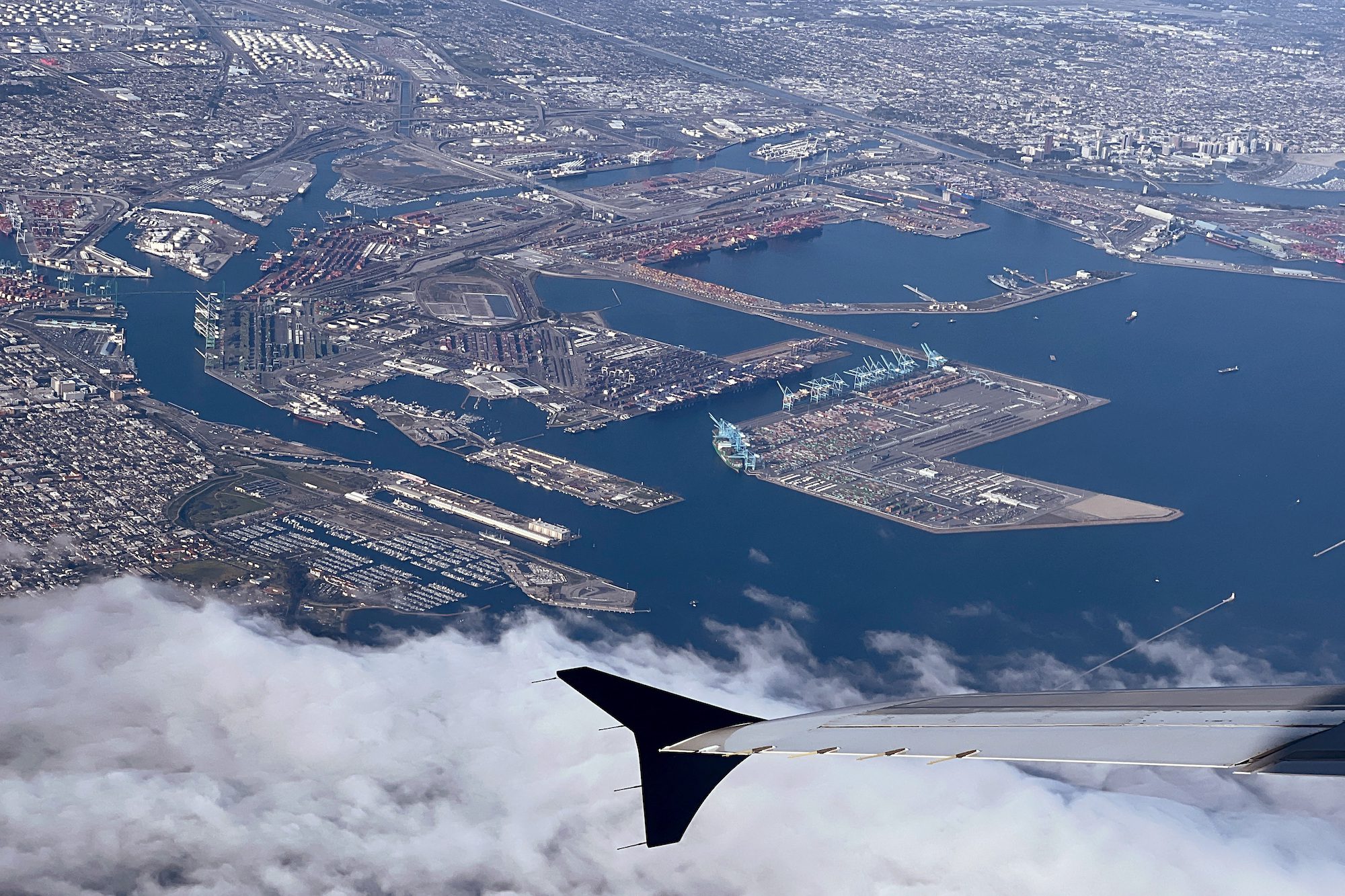 The shipping ports of Los Angeles (top left) and Long Beach are seen from the window of a commercial aircraft over Long Beach, California, U.S. March 13, 2023. REUTERS/Chris Helgren