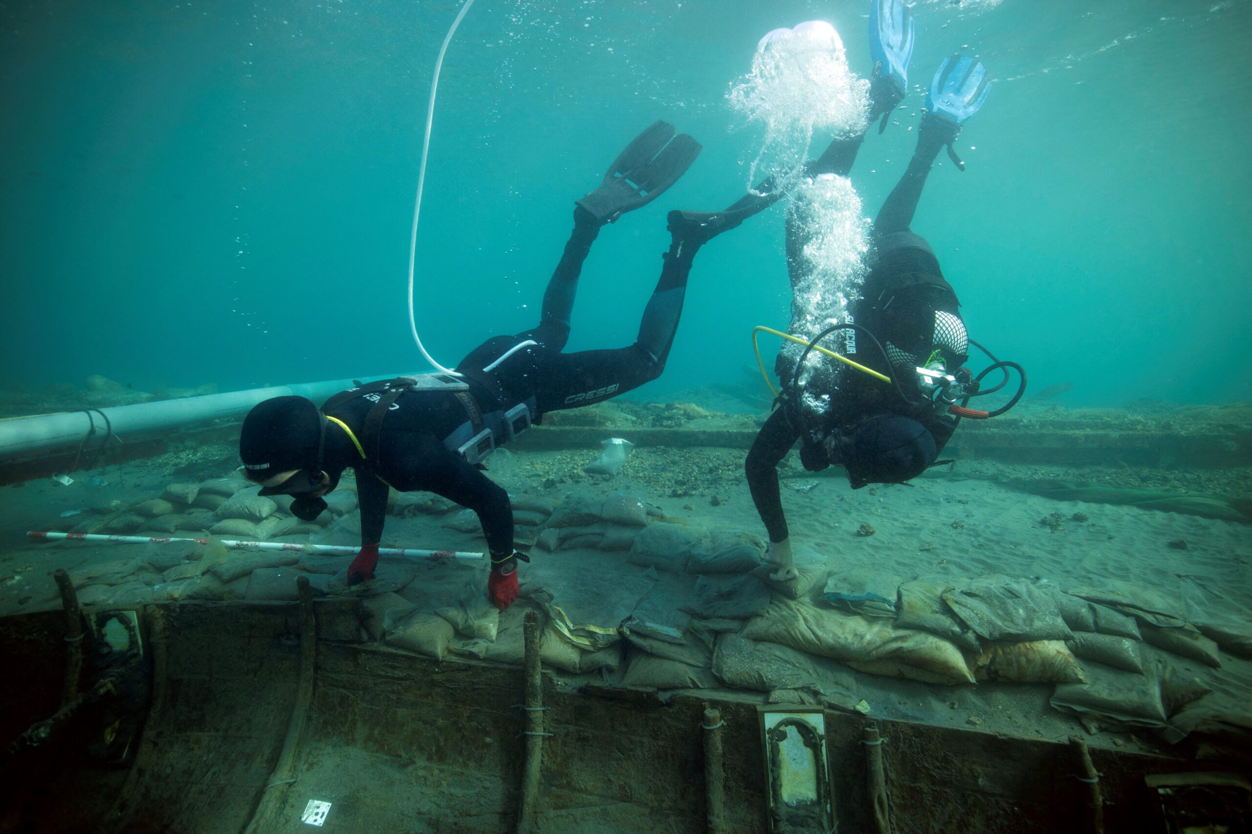 Divers from Valencia University map and assess the state of a 2,500-year-old Phoenician vessel that is submerged 60 meters from the beach of Mazarron, Spain, June 20, 2023. Jose A Moya/Regional Government of Murcia/Handout via REUTERS