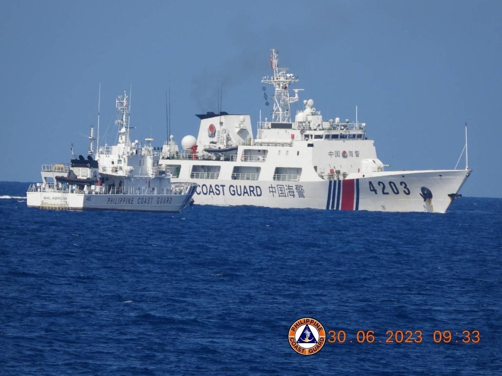 A Chinese Coast Guard ship allegedly obstructs the Philippine Coast Guard vessel Malabrigo as it provided support during a Philippine Navy operation near Second Thomas Shoal in the disputed South China Sea, June 30, 2023 in this handout image released July 5, 2023. Philippine Coast Guard/Handout via REUTERS