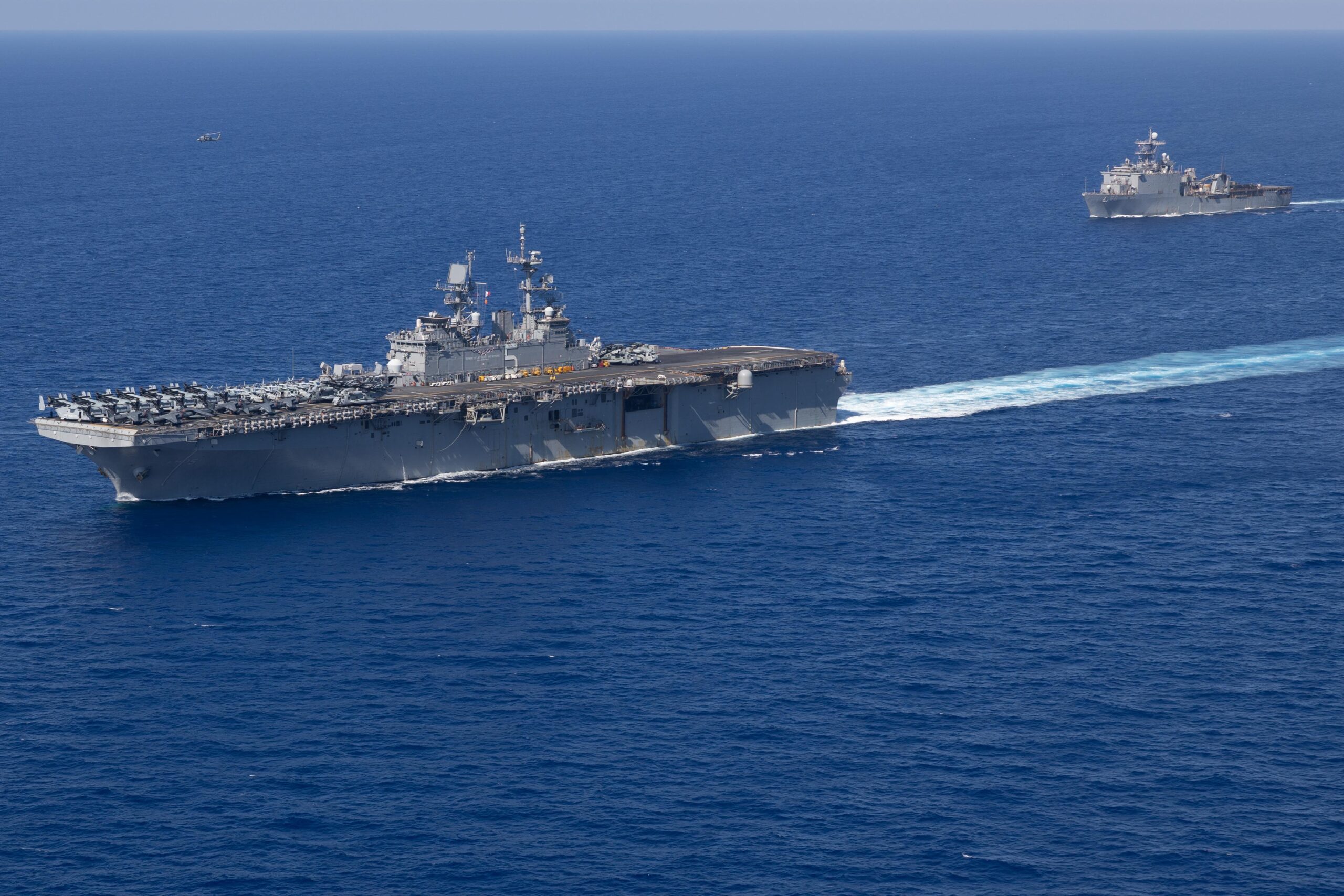 USS Bataan underway at sea with USS Carter in background