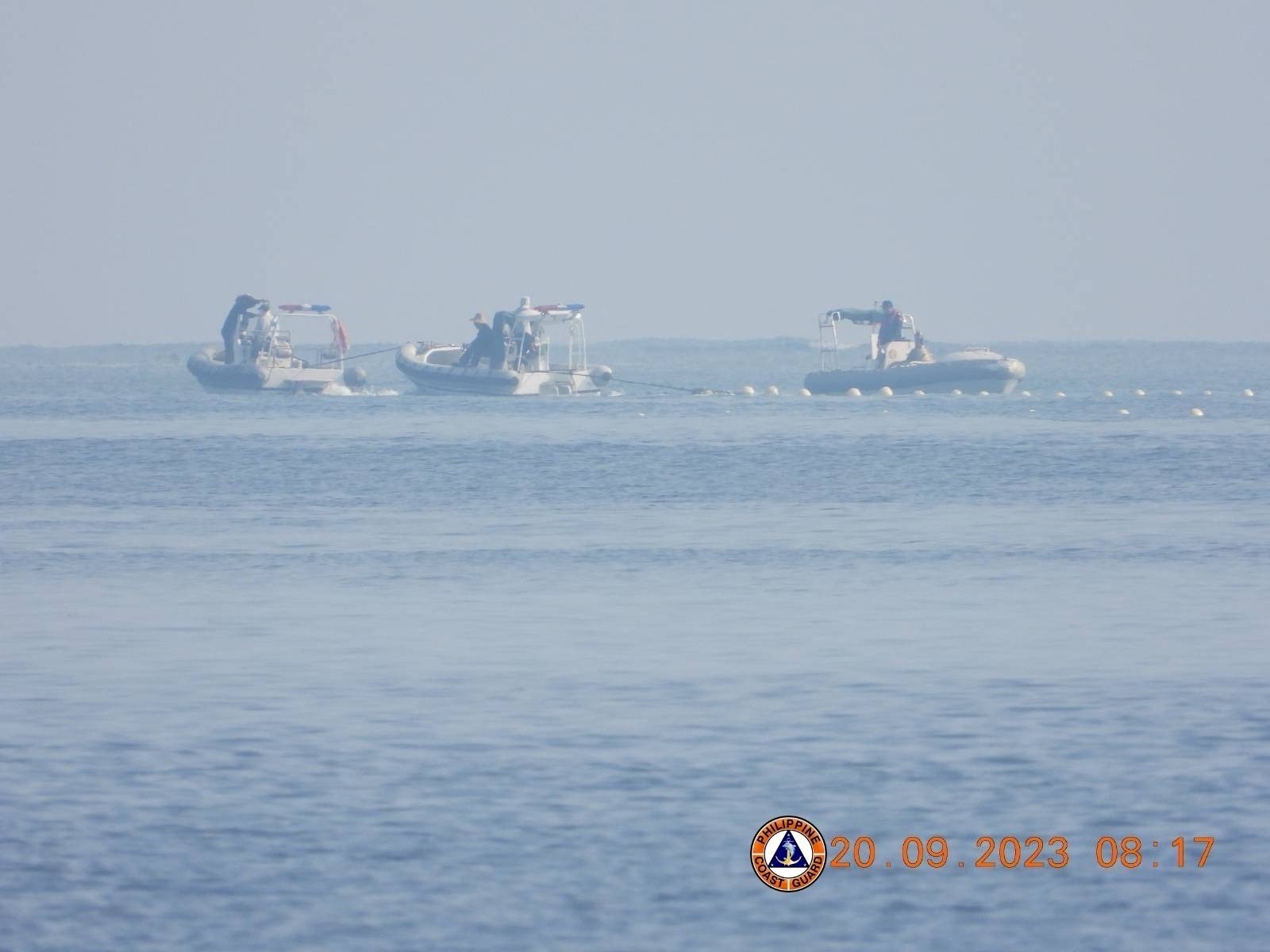 Chinese Coast Guard boats close to the floating barrier are pictured near the Scarborough Shoal.Philippine Coast Guard/Handout via REUTERS