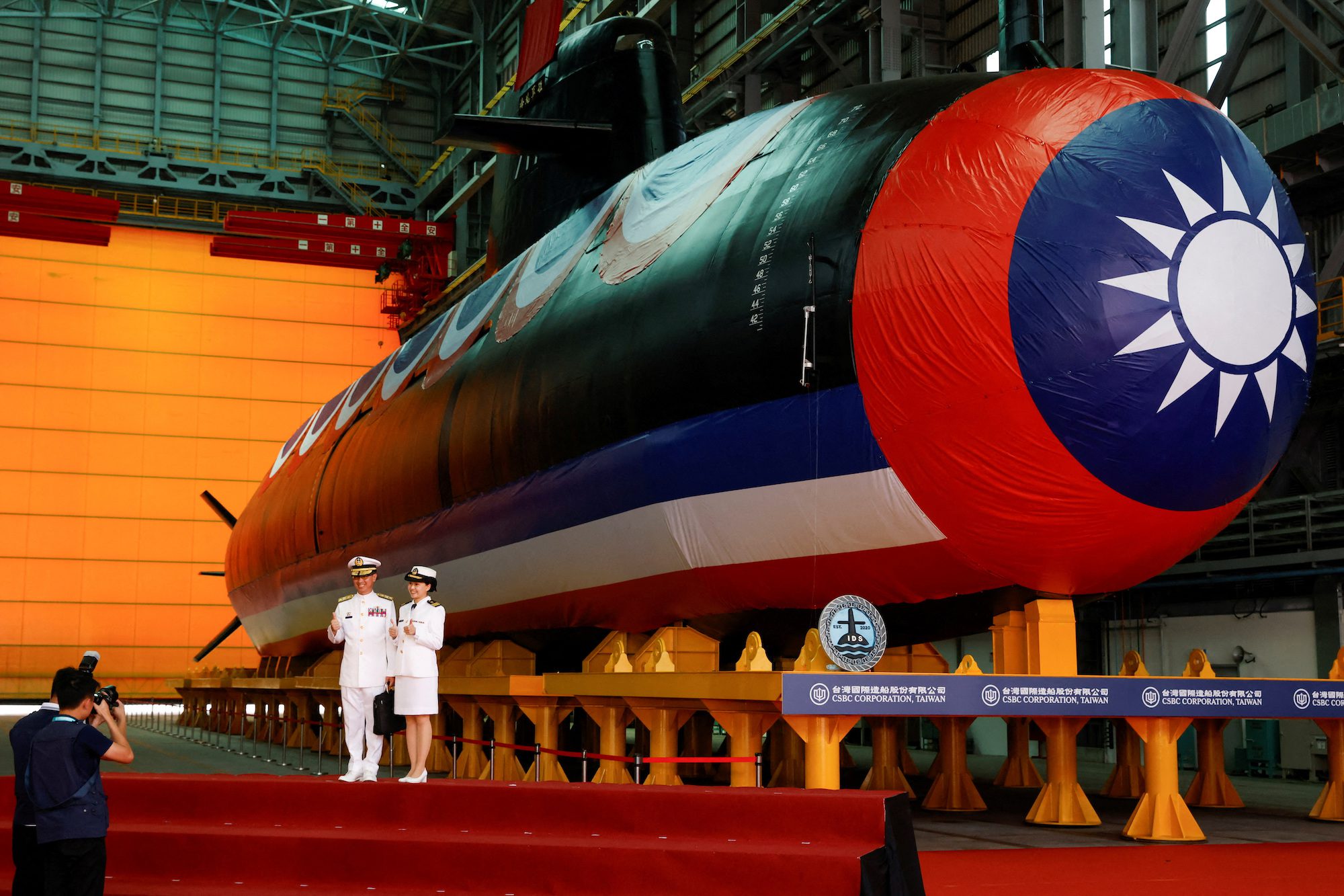 Members of the navy pose for pictures next to Narwhal, Taiwan's first domestically built submarine, after its launching ceremony in Kaohsiung, Taiwan September 28, 2023. REUTERS/Carlos Garcia Rawlins