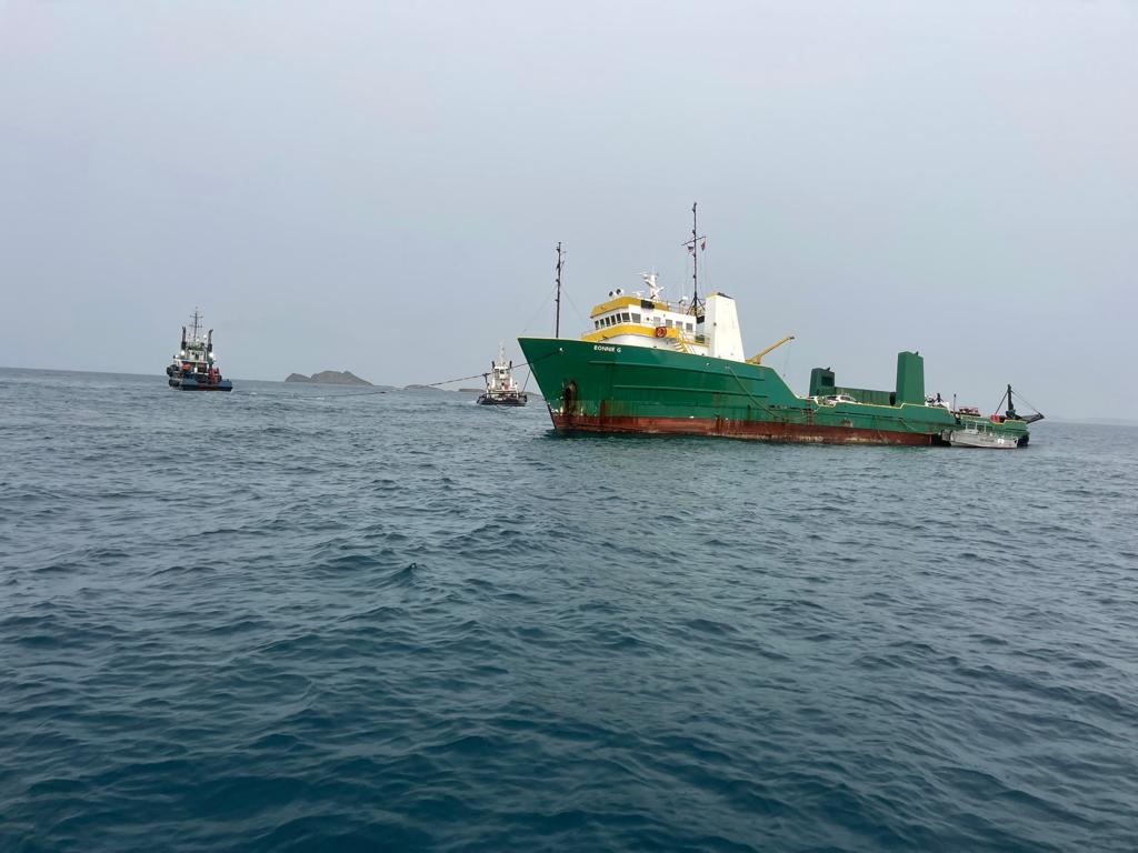 Two tugboats work to refloat the grounded Bonnie G cargo ship