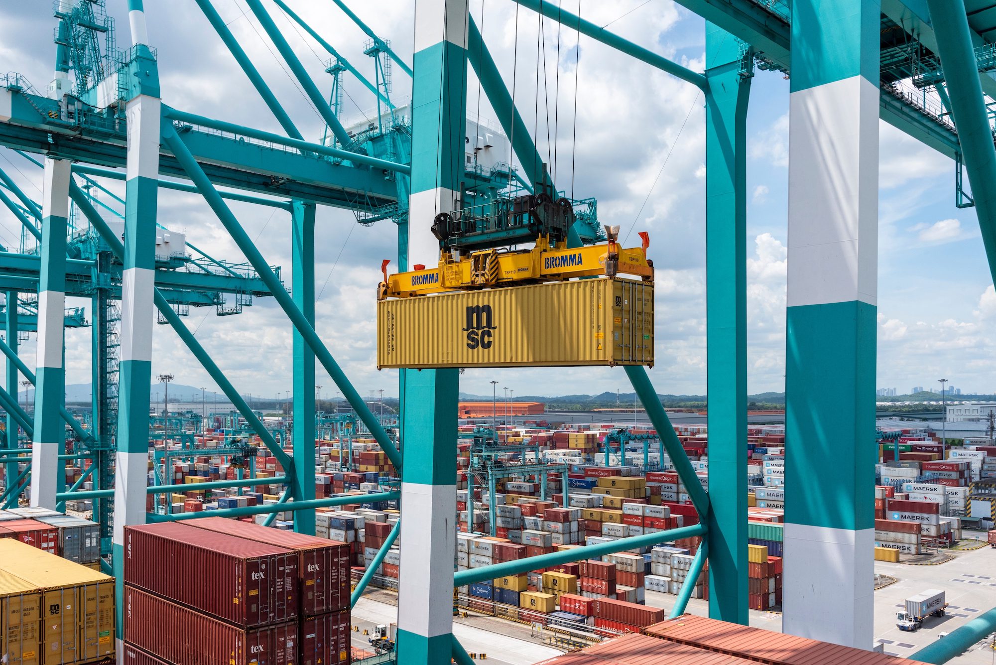 Stock photo shows a MSC shipping container being lifted onto a ship