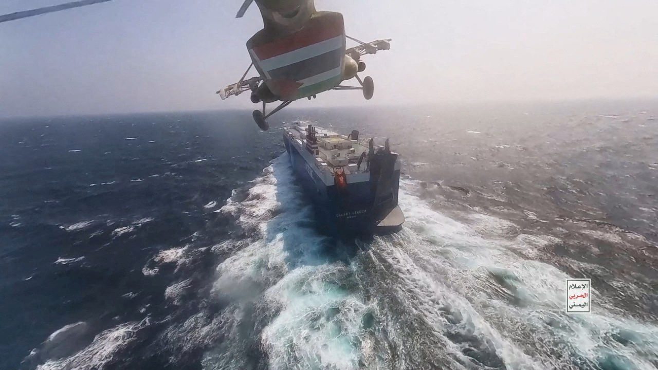 Houthi military helicopter flies over the Galaxy Leader cargo ship in the Red Sea in this photo released November 20, 2023. Houthi Military Media/Handout via REUTERS