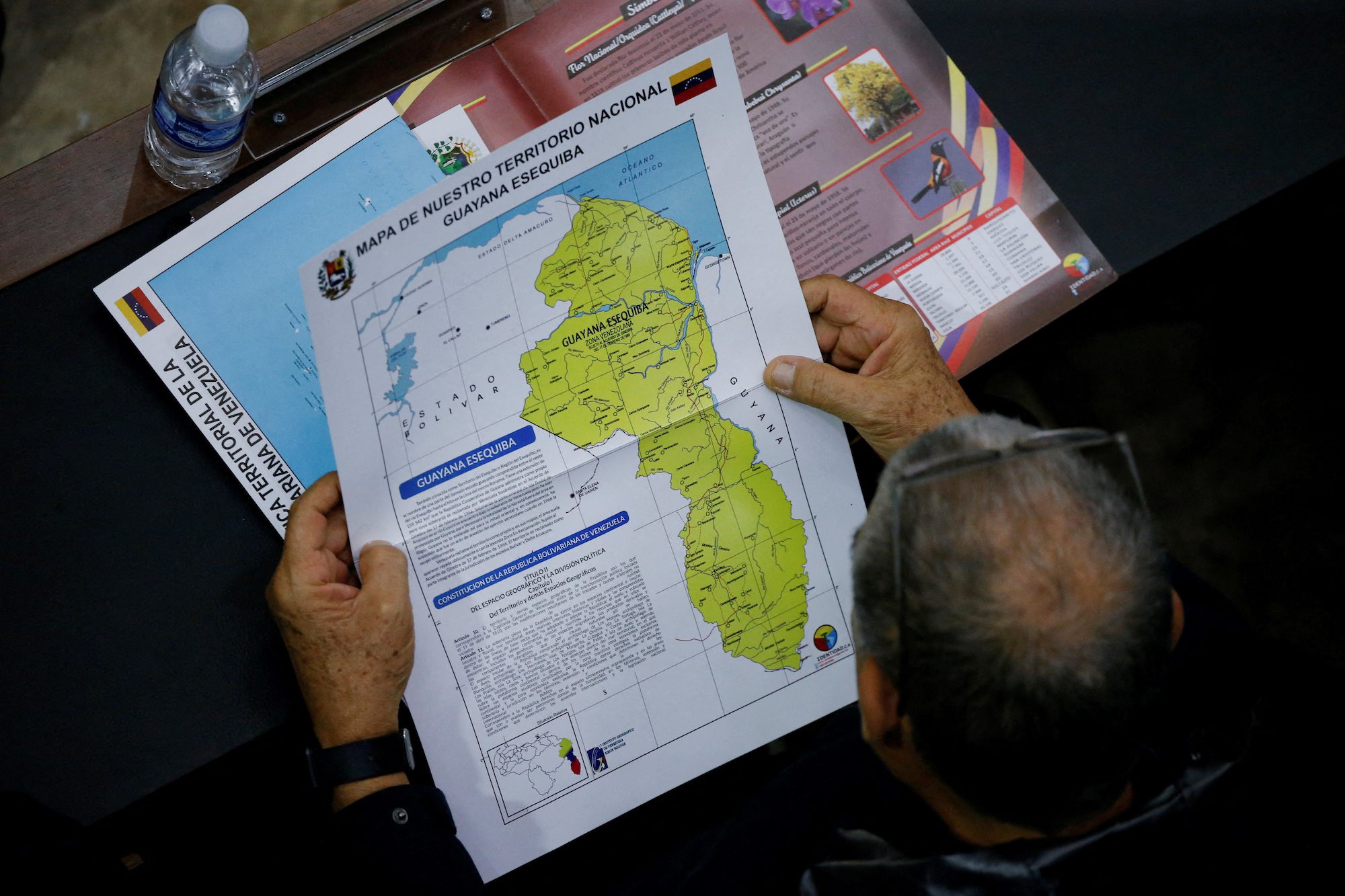 FILE PHOTO: A member of the National Assembly of the Assembly holds a map showing the disputed Esequibo region as part of Venezuela, as tensions between the Venezuela and Guyana have ratcheted up in recent weeks over a long-running territorial dispute, in Caracas, Venezuela, December 6, 2023. REUTERS/Leonardo Fernandez Viloria/File Photo