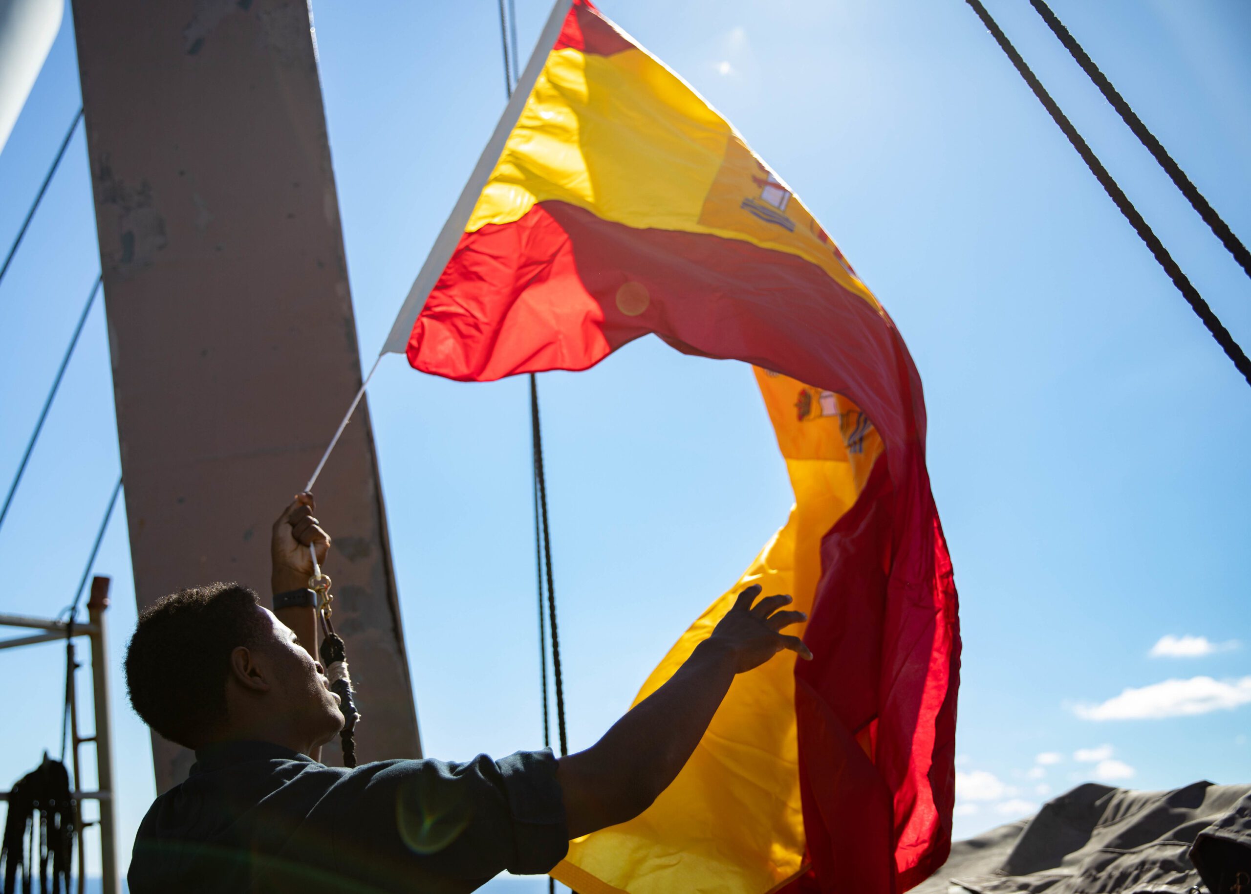 US Navy Sailor drops the Spanish flag