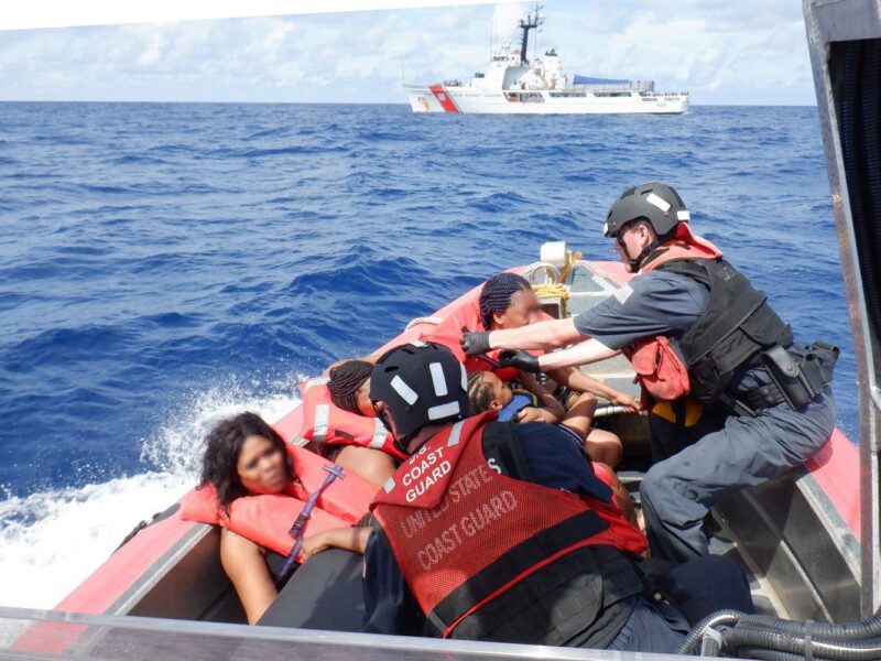 USCG small boat transfer of Haitian migrants to a nearby cutter.