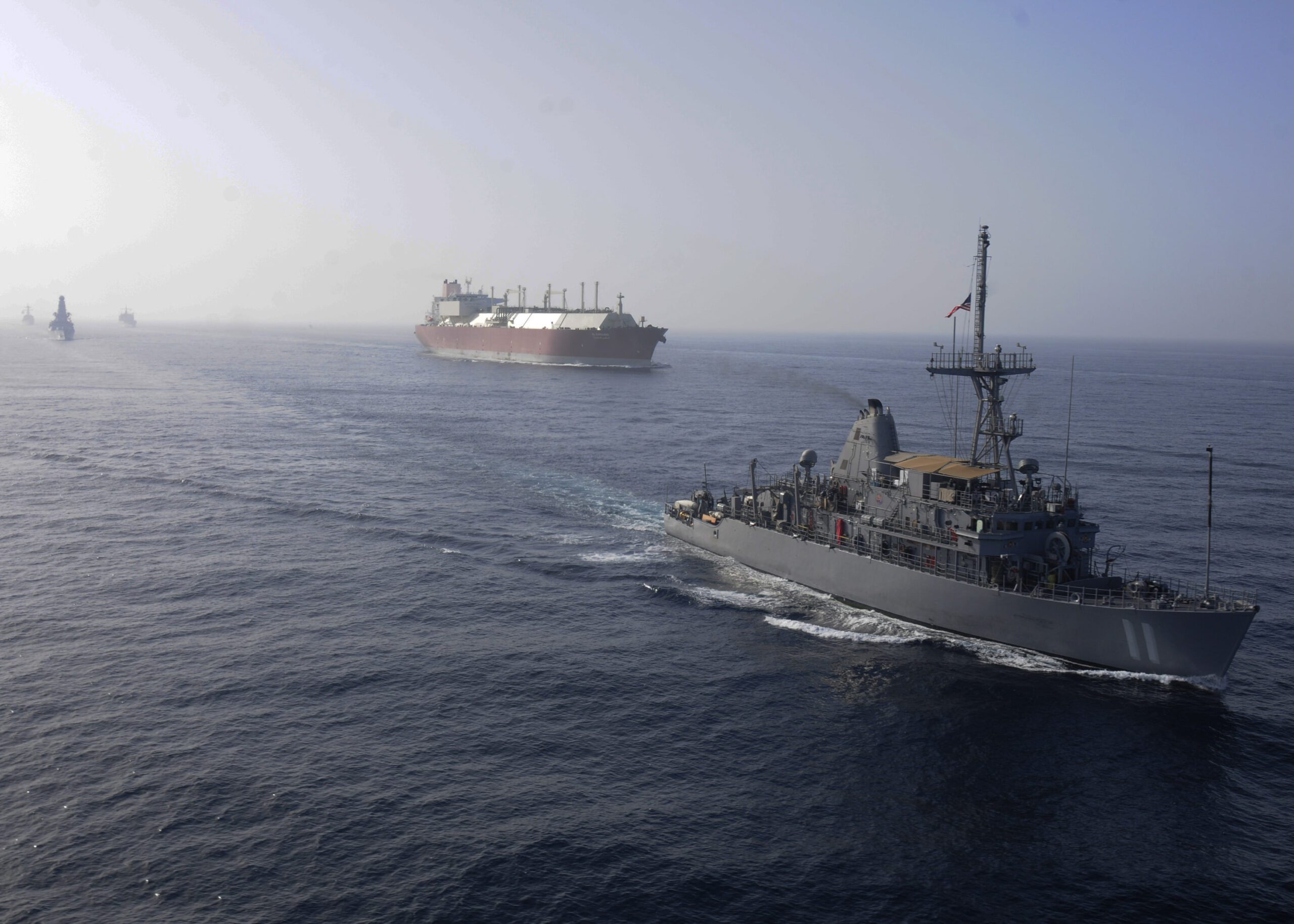 US Navy ship in a convoy with a LNG tanker