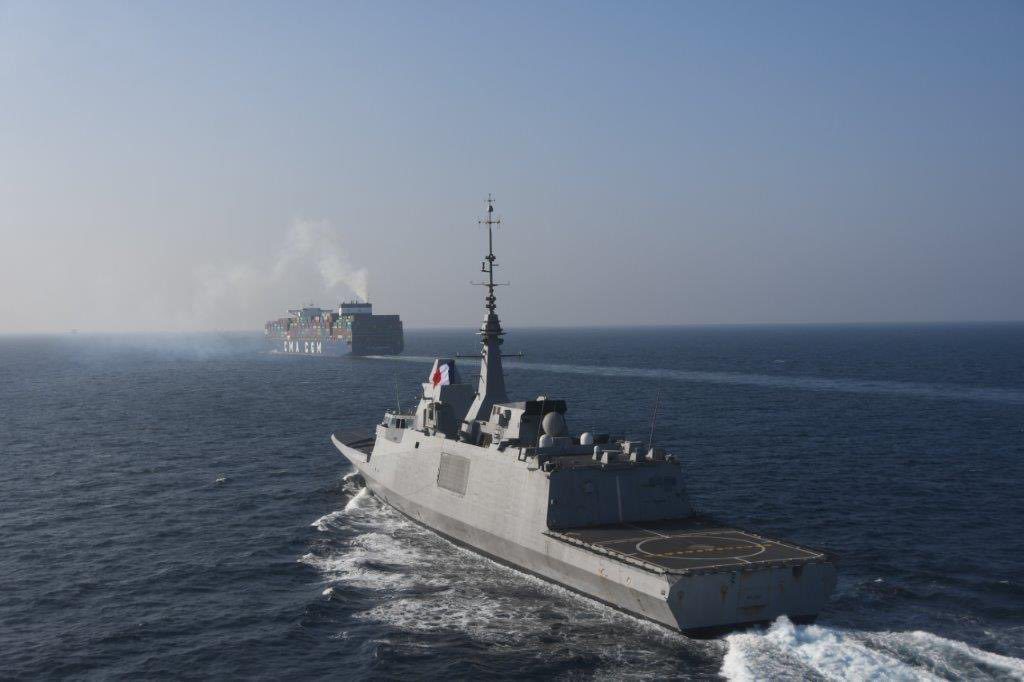 A French Navy warship escorts a CMA CGM containership in the Red Sea. Photo courtesy French Forces