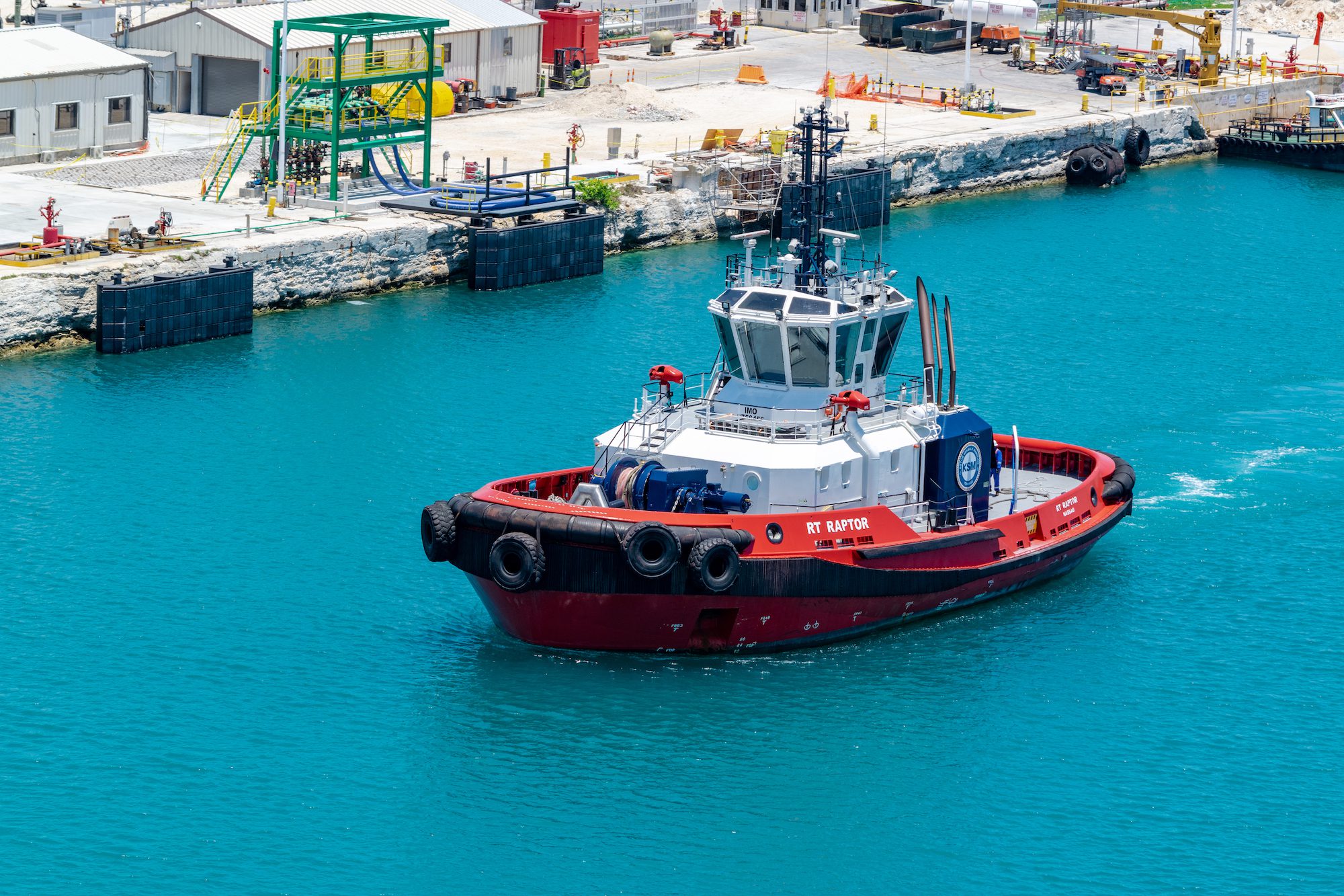 Feeport, Bahamas - May 2019: Tug boat RT Raptor near the pier close to the Freeport Container Port and Cruise Port