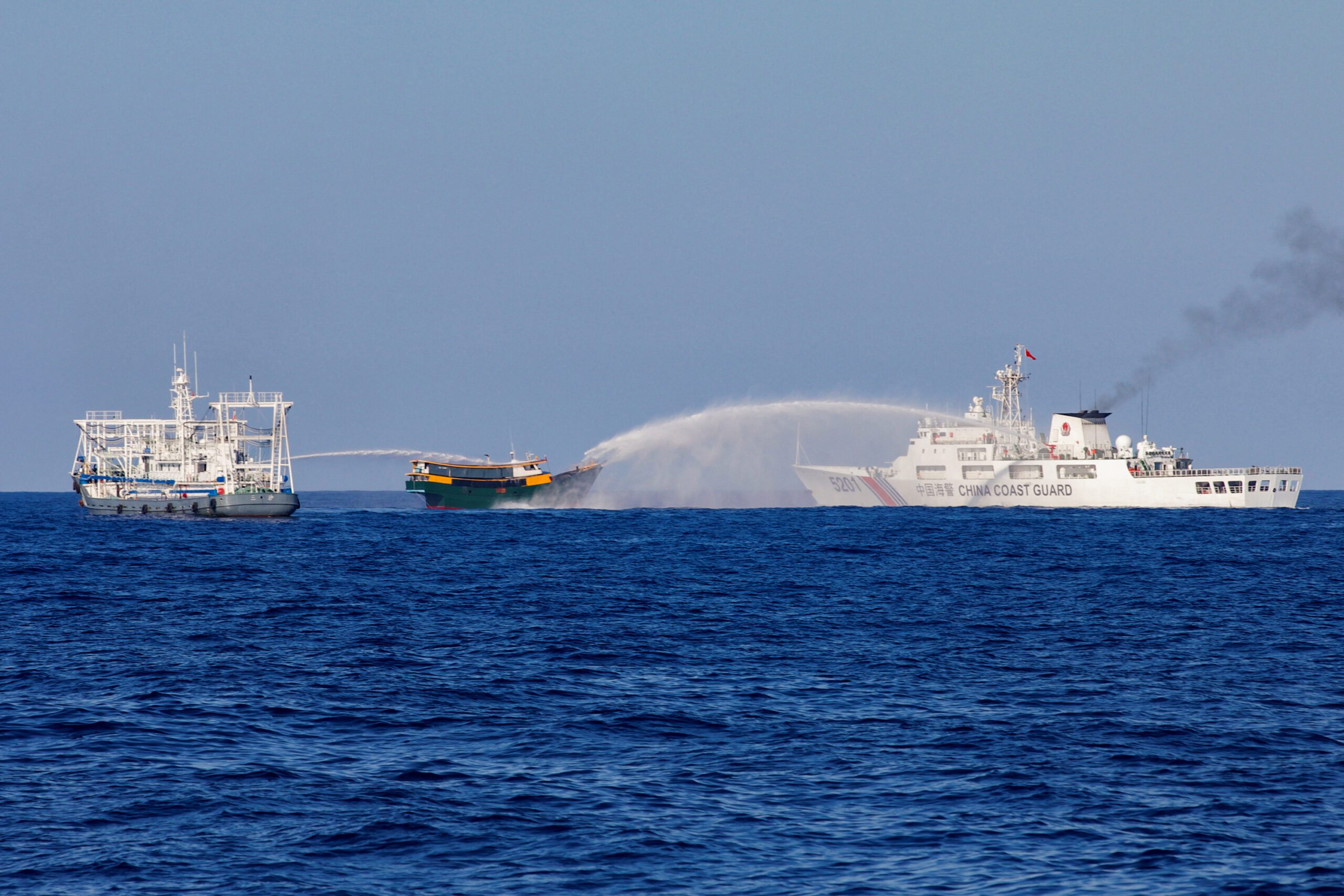 Chinese Coast Guard vessels fire water cannons towards a Philippine resupply vessel Unaizah May 4 on its way to a resupply mission at Second Thomas Shoal in the South China Sea. REUTERS/Adrian Portugal