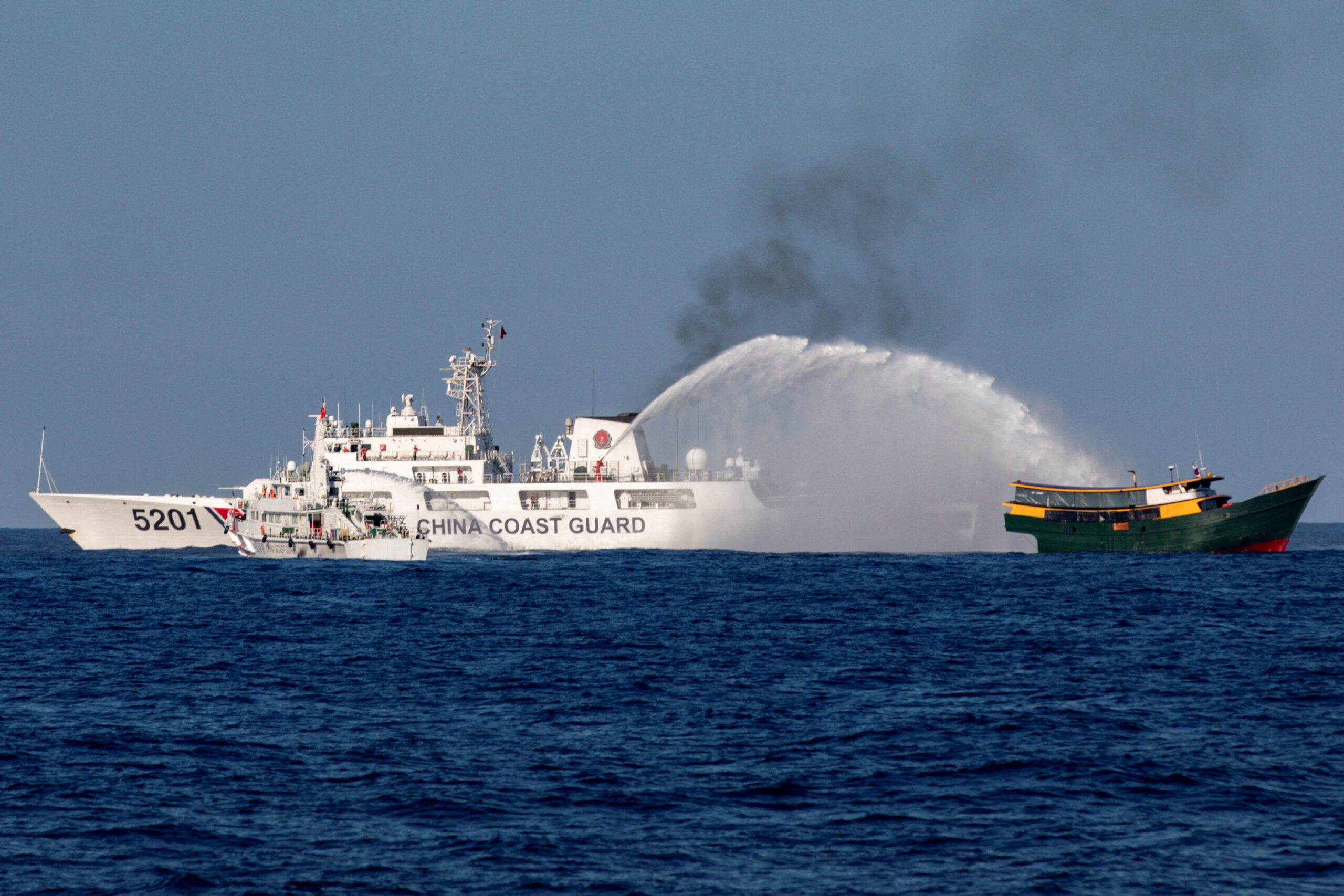 Chinese Coast Guard vessels fire water cannons towards a Philippine resupply vessel Unaizah May 4 on its way to a resupply mission at Second Thomas Shoal in the South China Sea. REUTERS/Adrian Portugal TPX IMAGES OF THE DAY