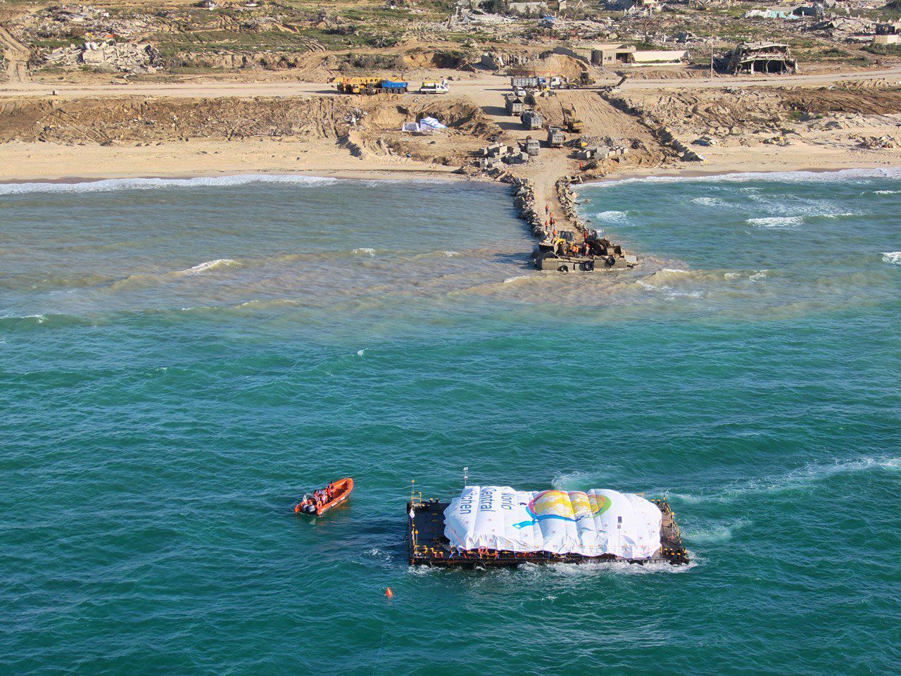 A barge carrying food aid arrives at a temporary jetty in Gaza