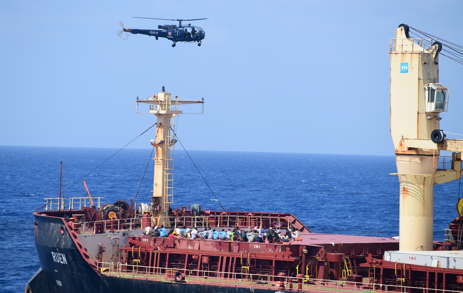 An Indian Navy helicopter hovers over captured pirates on the deck of the MV Ruen after retaking the ship. Photo courtesy Indian Navy