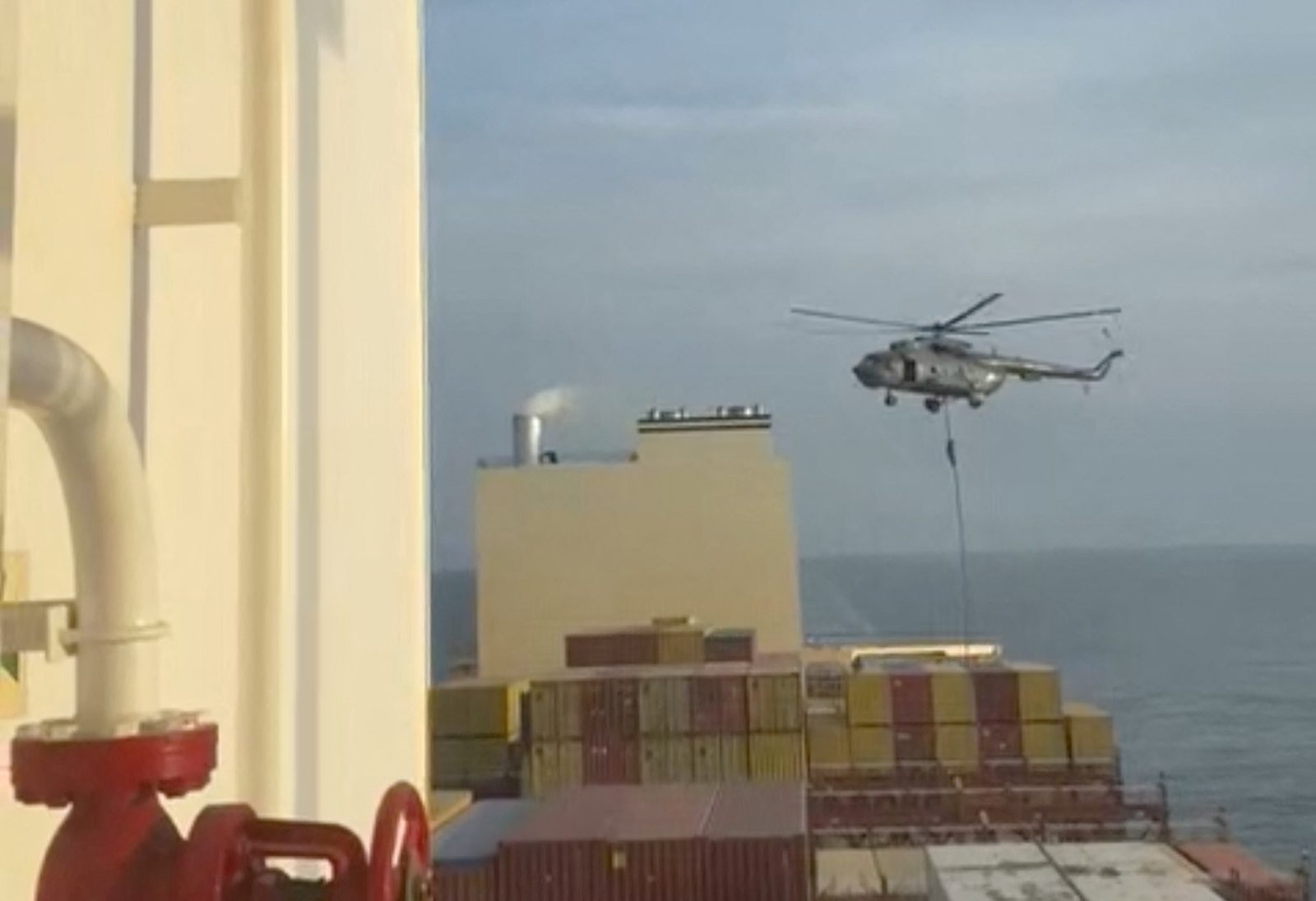An official slides down a rope during a helicopter raid on MSC Aries ship at sea in this screen grab obtained from a social media video released on April 13, 2024. Video obtained by Reuters/via REUTERS