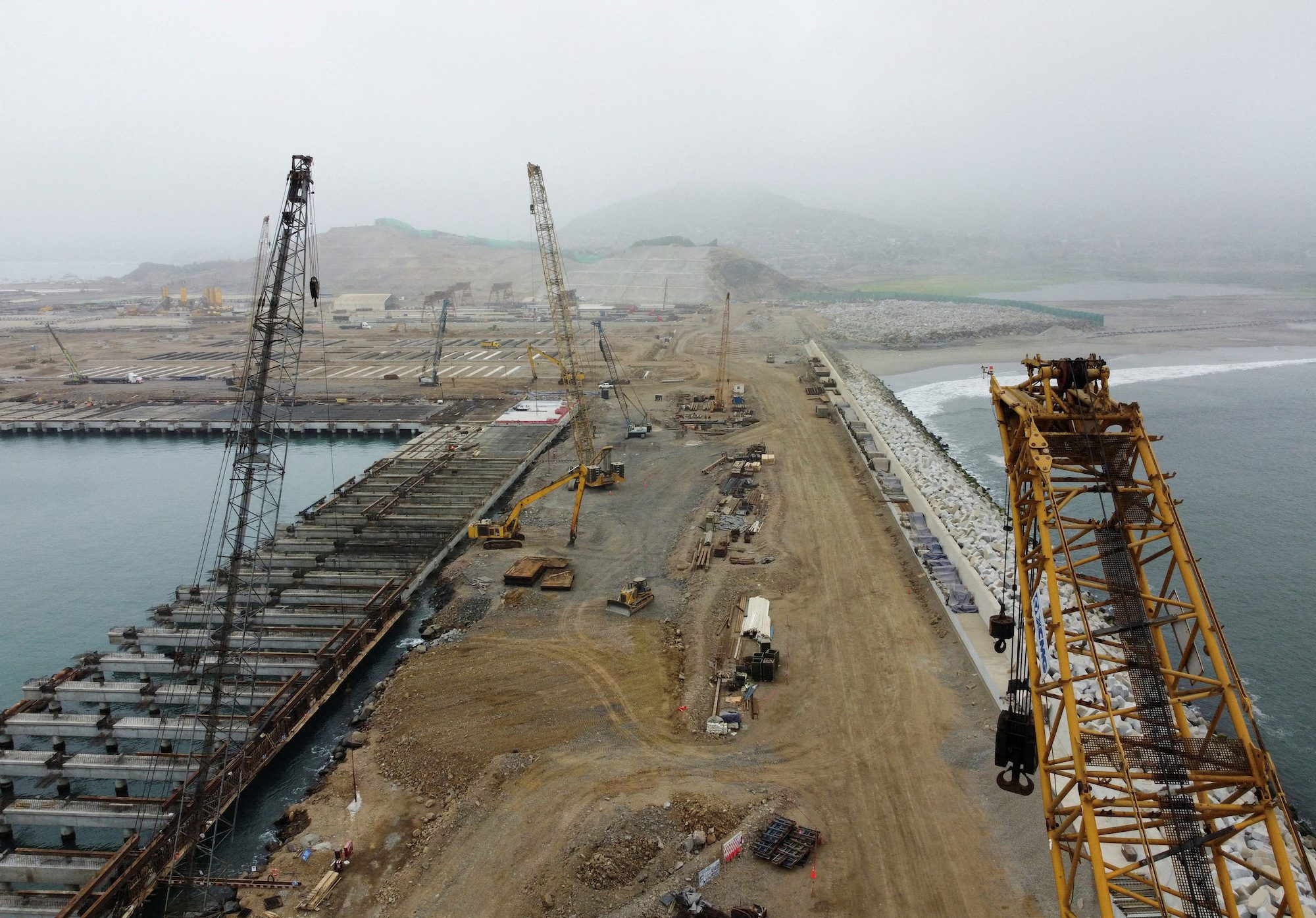 FILE PHOTO: Dragline excavators stand at the construction site of a new Chinese mega port, in Chancay, Peru August 22, 2023. REUTERS/Angela Ponce/File