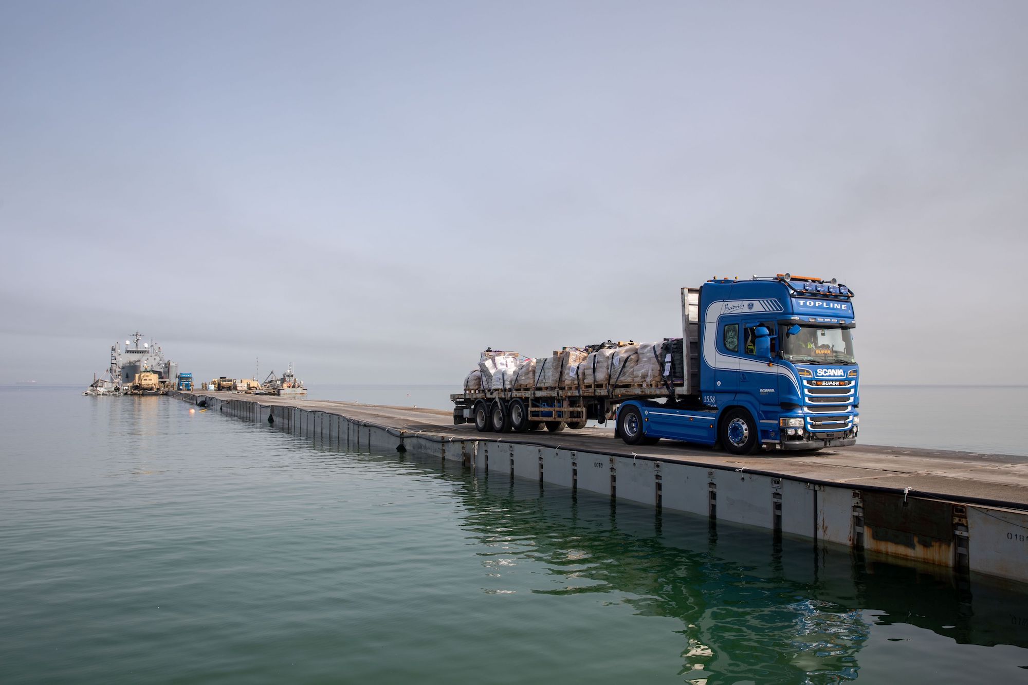 A DoD-contracted driver transports humanitarian aid across the Trident Pier before entering the beach in Gaza May 19, 2024. U.S. Army Photo