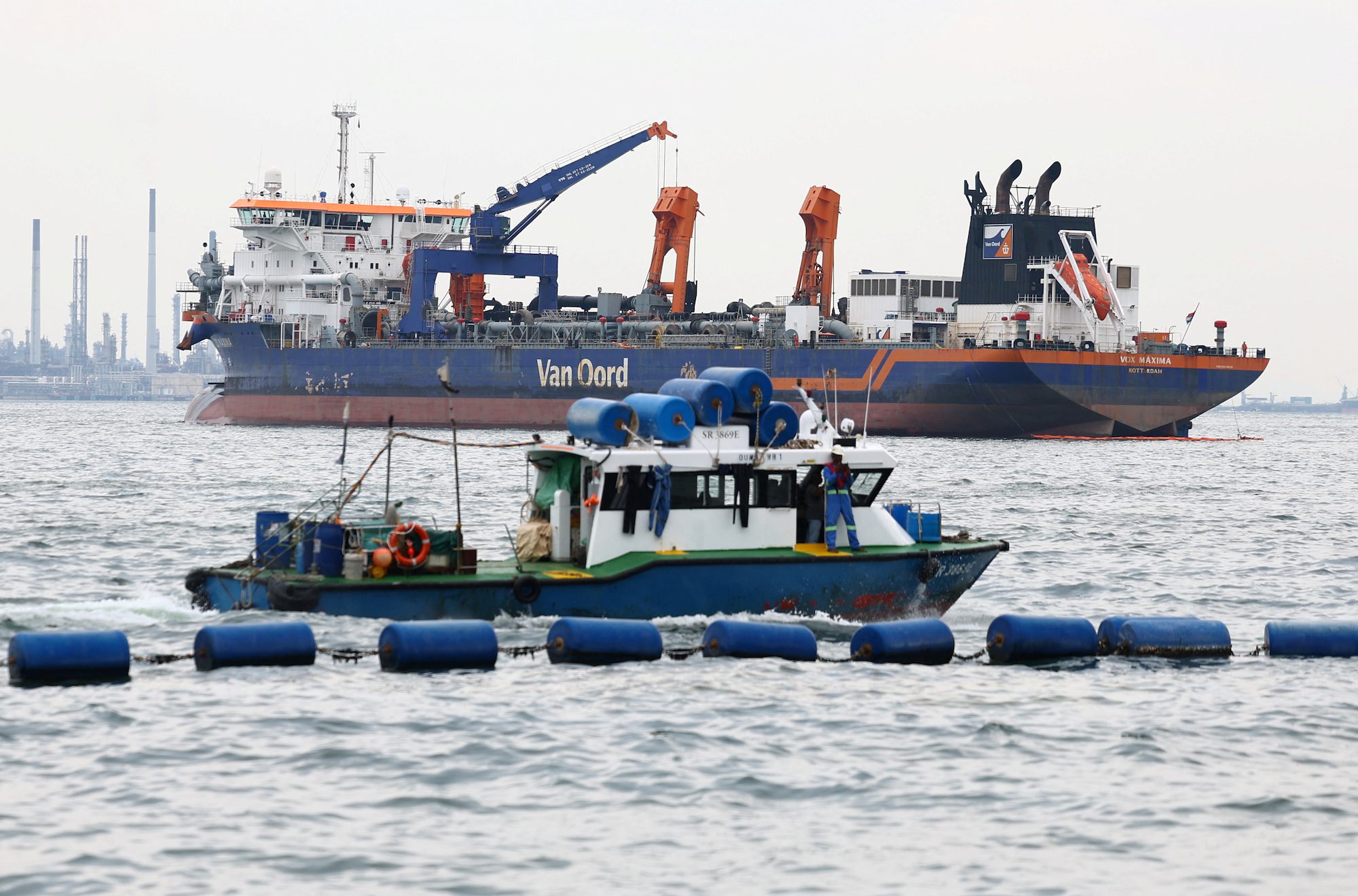 Dredging vessel Vox Maxima is seen in the waters off Sentosa after a collision with a bunker vessel resulting in an oil spill, in Singapore, June 15, 2024. REUTERS/Edgar Su