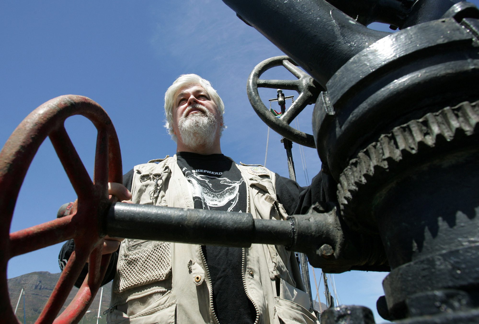 FILE PHOTO: Canadian Paul Watson, the captain of the anti-whaling ship the Farley Mowat, stands on the deck of the boat in Cape Town, South Africa January 30, 2006. REUTERS/Howard Burditt/File Photo