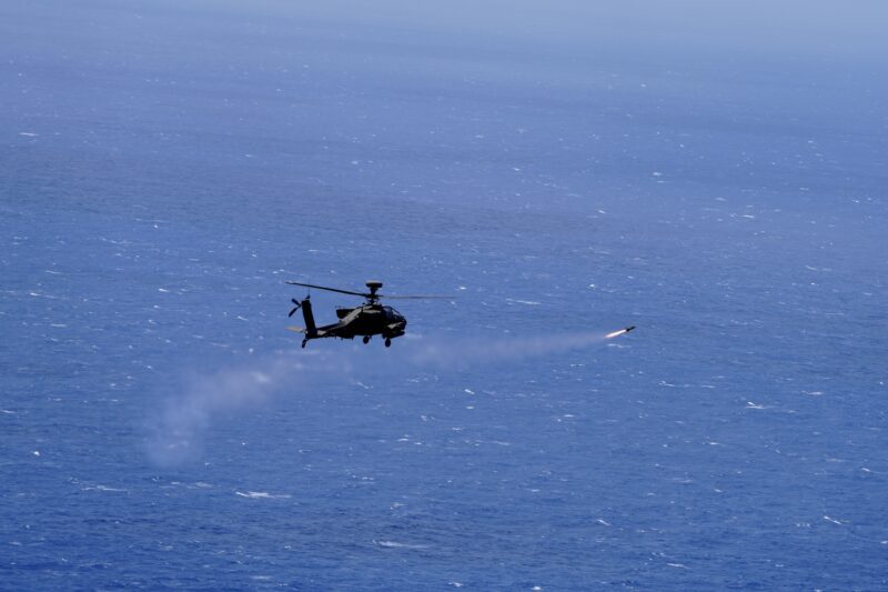 An AH-64 Apache helicopter attached 2nd Battalion, 6th Cavalry Squadron, 25th Combat Aviation Brigade, 25th Infantry Division shoots a AGM-114 Hellfire missile towards the decommissioned Austin-class amphibious transport dock USS Dubuque for a long planned, live fire sinking exercise (SINKEX) off the coast of Kauai during Exercise Rim of the Pacific (RIMPAC) 2024, July 11, 2024. U.S. Army Photo