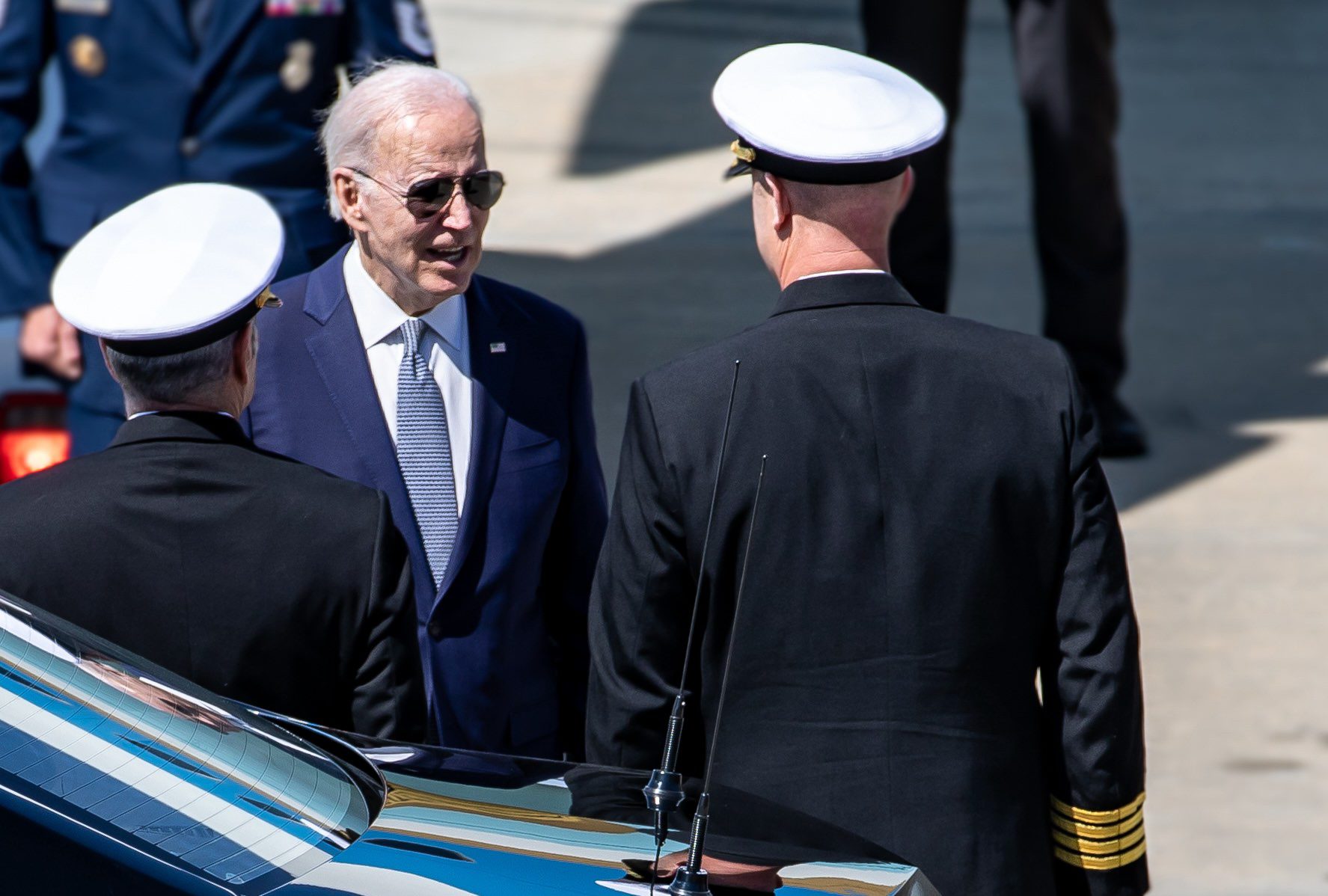 President Biden talks with US Naval officers after departing Air Force 1