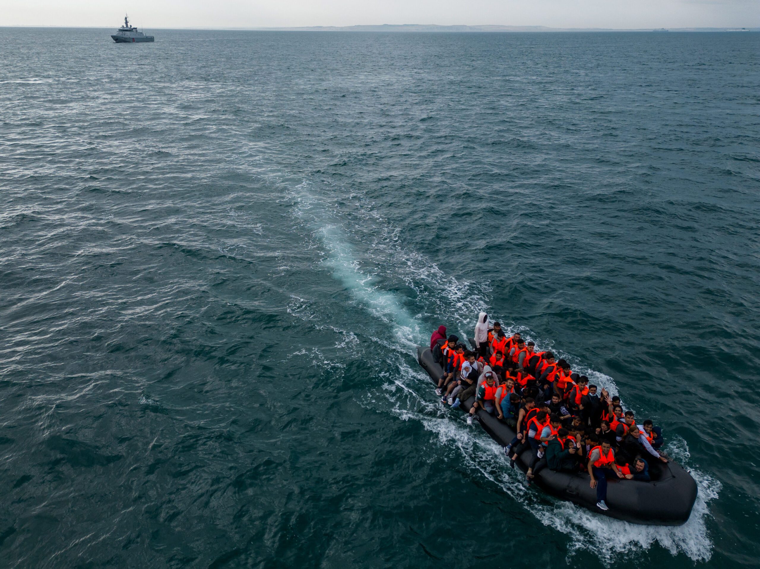 Migrants cross the English channel from France to Britian in boats wearing lifejackets